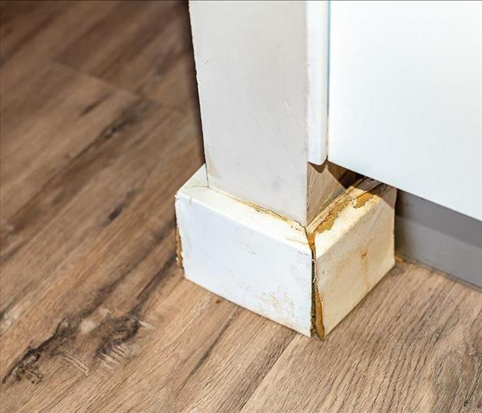 White baseboards with water damage 